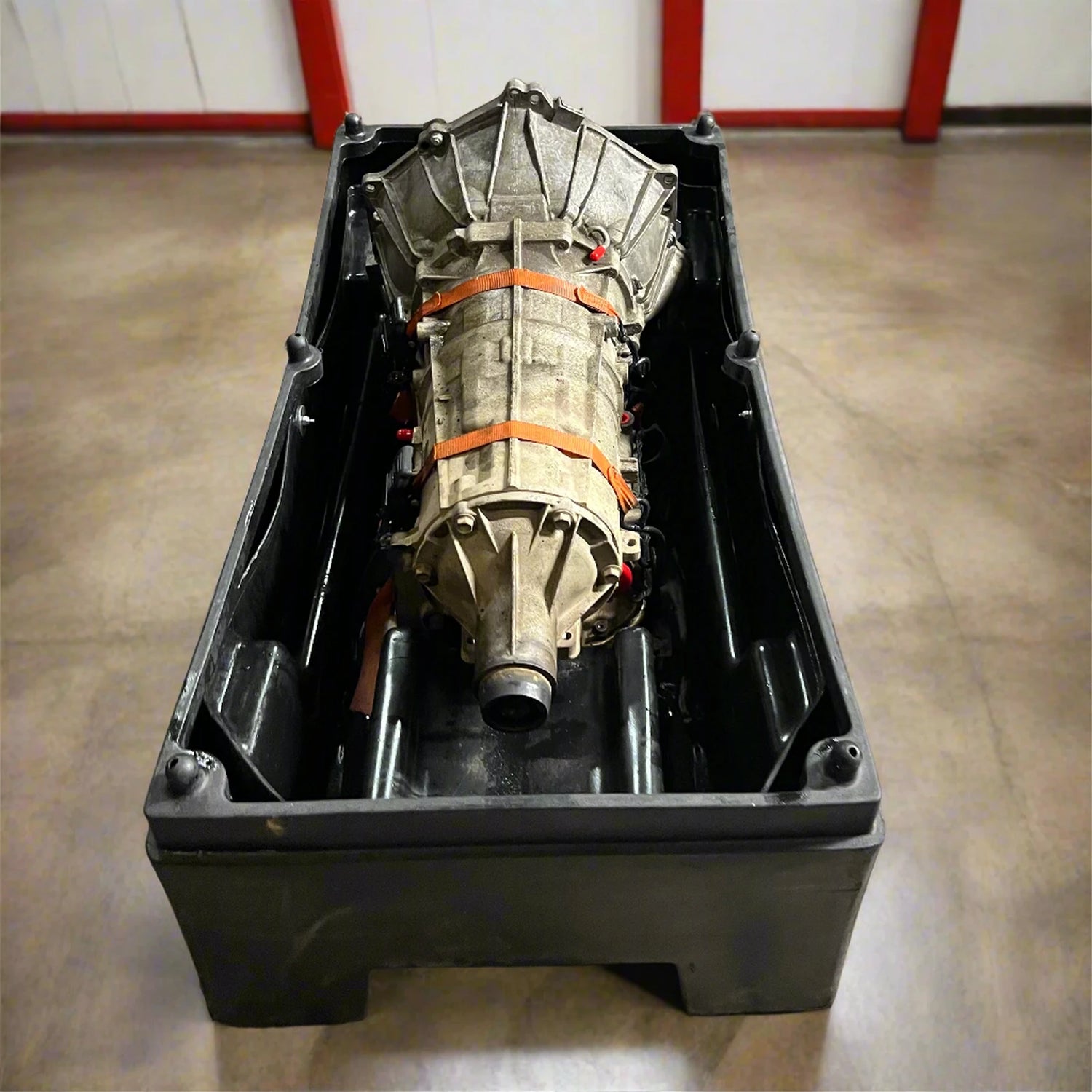 Used GM 6L80 transmission core secured in a return container — Quantum Gear core return process.