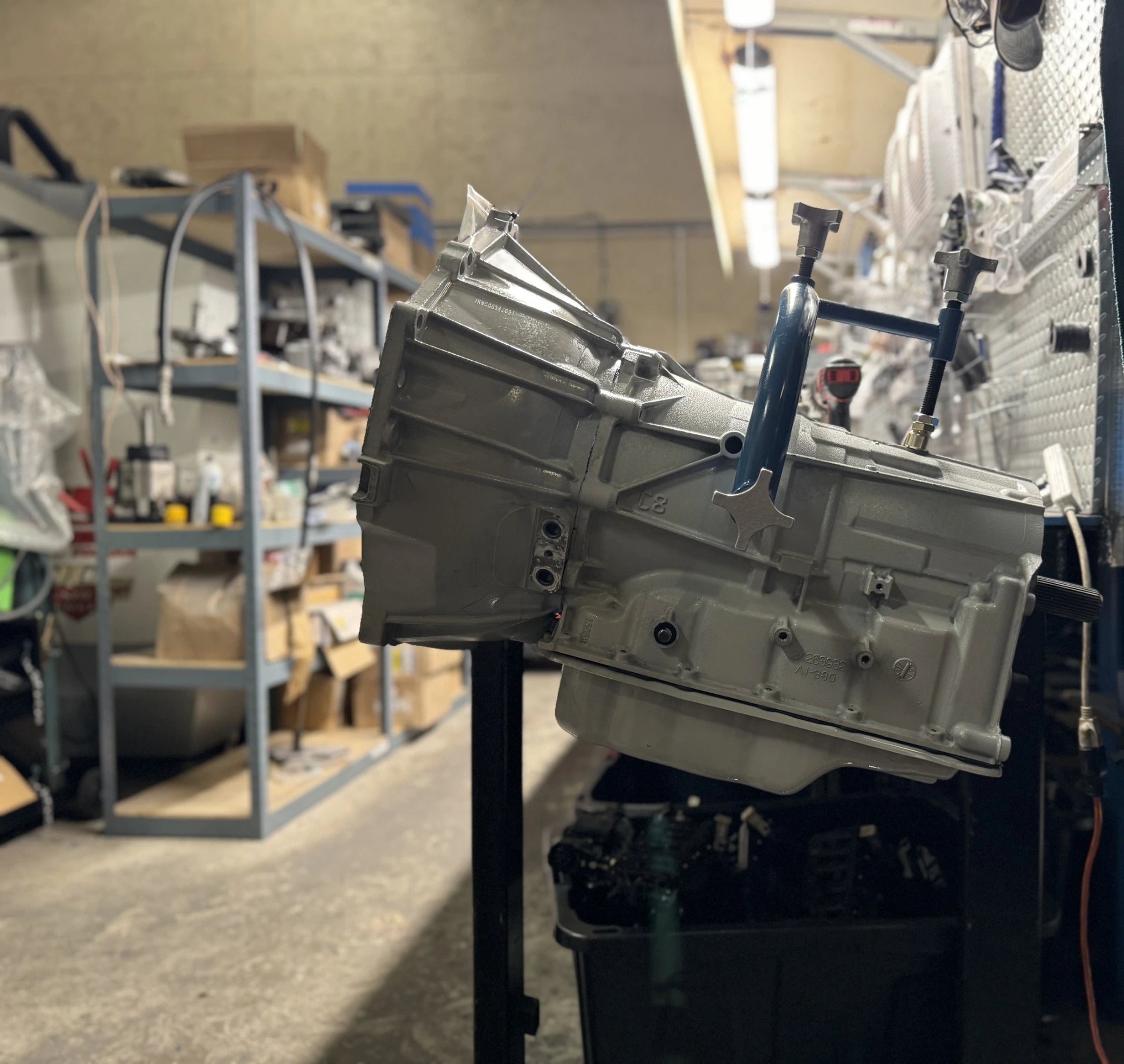 Remanufactured GM transmission on a test stand inside the Quantum Gear workshop — part of the rebuilding process.